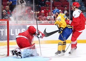 MONTREAL, CANADA - DECEMBER 26: Denmark's Lasse Petersen #30 makes the save while getting a face full of snow from Sweden's Sebastian Ohlsson #25 while Mathias Rondbjerg #7 looks on during preliminary round action at the 2017 IIHF World Junior Championship. (Photo by Andre Ringuette/HHOF-IIHF Images)

