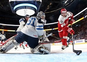 MONTREAL, CANADA - DECEMBER 27: Denmark's William Boysen #18 scores a first period goal against Finland's Veini Vehvilainen #31 during preliminary round action at the 2017 IIHF World Junior Championship. (Photo by Andre Ringuette/HHOF-IIHF Images)

