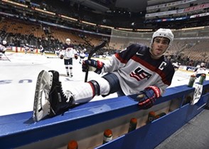 TORONTO, CANADA - DECEMBER 28: USA's Luke Kunin #9 sticks his tongue out while stretching by the bench during warm up before taking on Slovakia in the preliminary round of the 2017 IIHF World Junior Championship. (Photo by Matt Zambonin/HHOF-IIHF Images)

